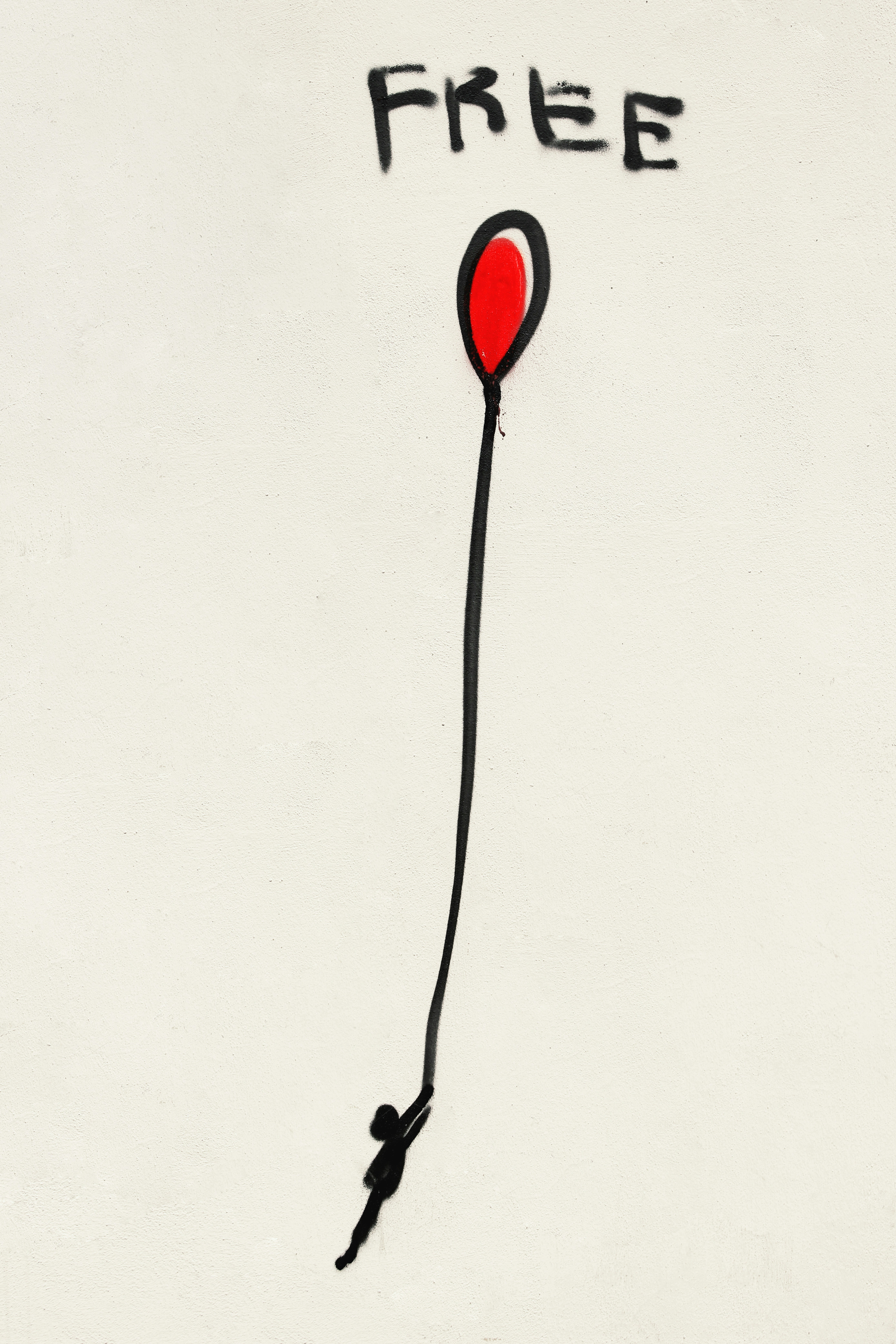 An abstract line art drawing of a person lifted by a balloon with a red center and the word free, representing creative metaphor, visual tools, and online therapy across the UK.